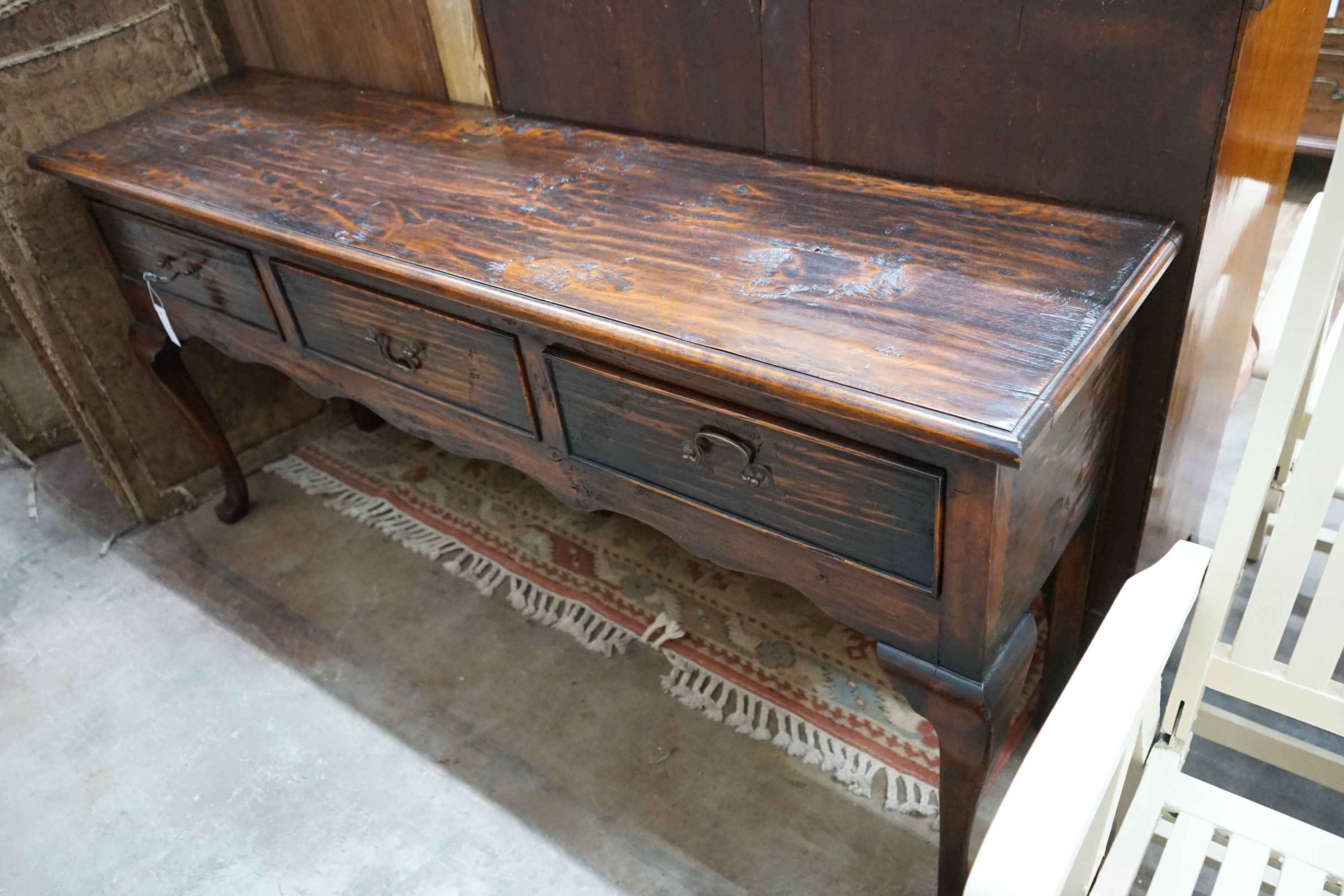 A reproduction 18th century style oak low dresser, length 170cm, depth 43cm, height 81cm